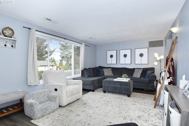 living room with wood finished floors and visible vents