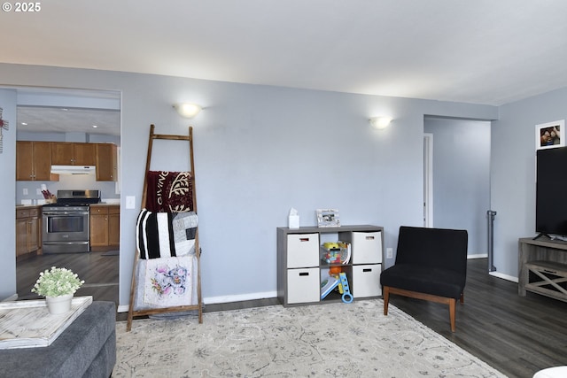 living area featuring baseboards and wood finished floors