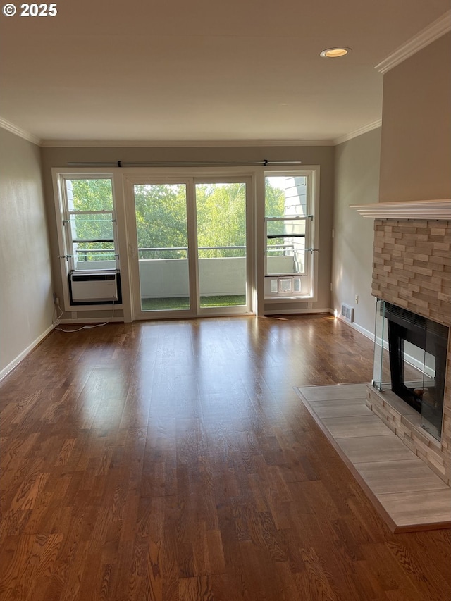 4970 S Landing Dr Unit 302, Portland, OR 97239 - unfurnished living room with plenty of natural light, ornamental molding, a stone fireplace, and dark wood-type flooring