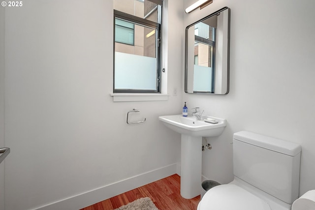 1634 NW Riverscape St, Portland, OR 97209 - bathroom featuring toilet, wood finished floors, and baseboards