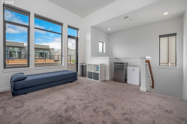 1634 NW Riverscape St, Portland, OR 97209 - living area featuring an upstairs landing, carpet, baseboards, and recessed lighting