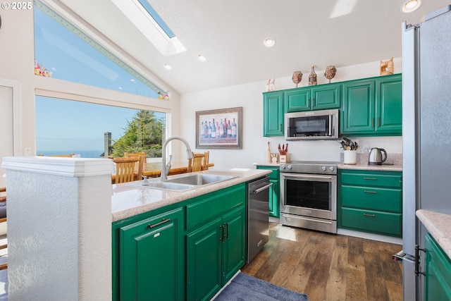 461 Home Ct, Rockaway Beach, OR 97136 - kitchen with appliances with stainless steel finishes, vaulted ceiling, light countertops, a skylight, and dark wood-style flooring