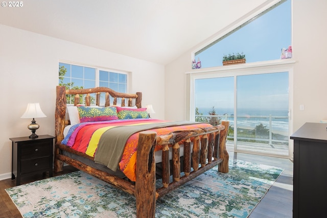 461 Home Ct, Rockaway Beach, OR 97136 - bedroom featuring access to exterior, multiple windows, vaulted ceiling, and wood finished floors