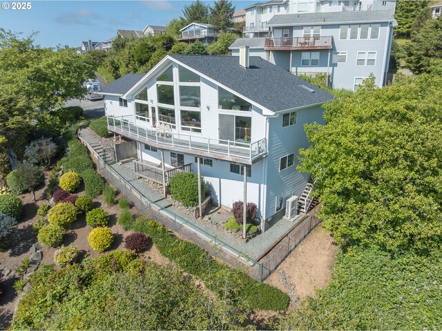 461 Home Ct, Rockaway Beach, OR 97136 - rear view of house featuring a balcony and a shingled roof