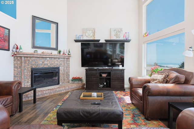 461 Home Ct, Rockaway Beach, OR 97136 - living area featuring wood finished floors, a fireplace, and a towering ceiling