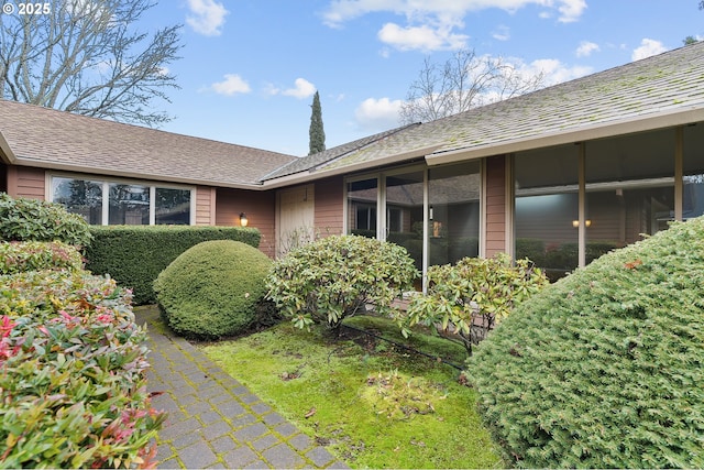 view of home's exterior with a shingled roof