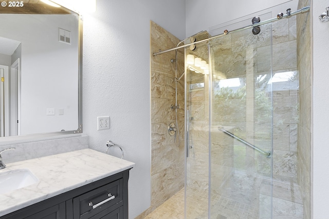 bathroom featuring vanity and a shower with door