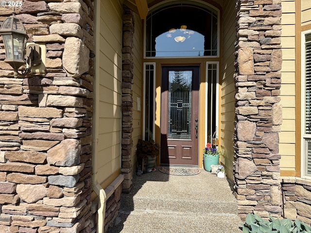 property entrance featuring stone siding