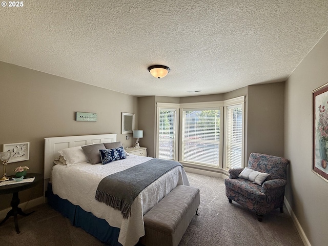 bedroom with carpet, baseboards, and a textured ceiling