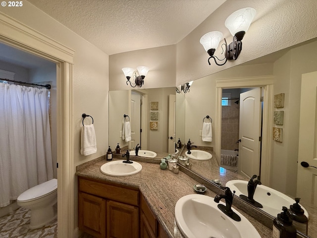 full bathroom with a textured ceiling, toilet, double vanity, a chandelier, and a shower with curtain