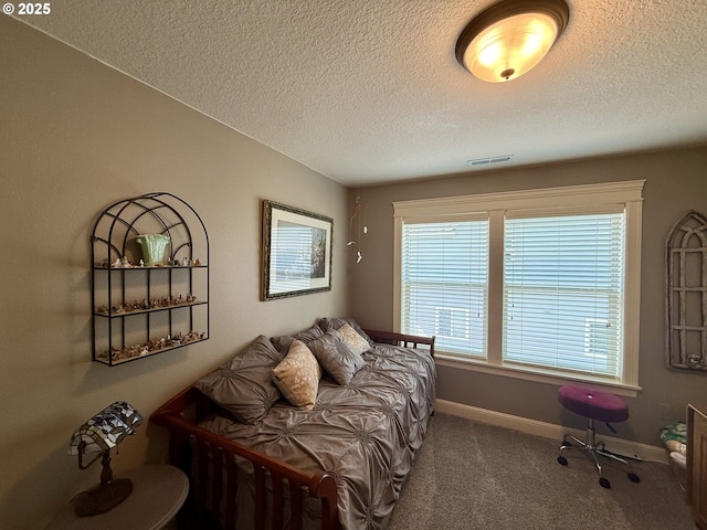 bedroom featuring carpet floors, a textured ceiling, and baseboards