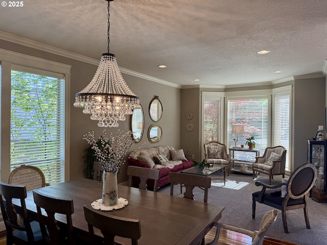 dining room with a chandelier, a textured ceiling, recessed lighting, carpet floors, and ornamental molding