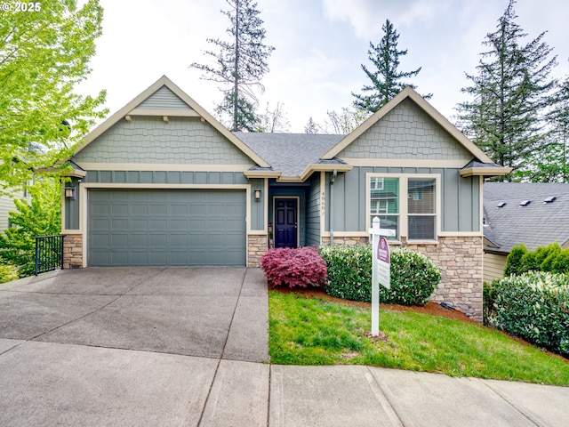 craftsman inspired home with a garage, board and batten siding, concrete driveway, and stone siding