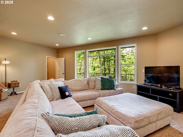 carpeted living room featuring baseboards, recessed lighting, and a textured ceiling