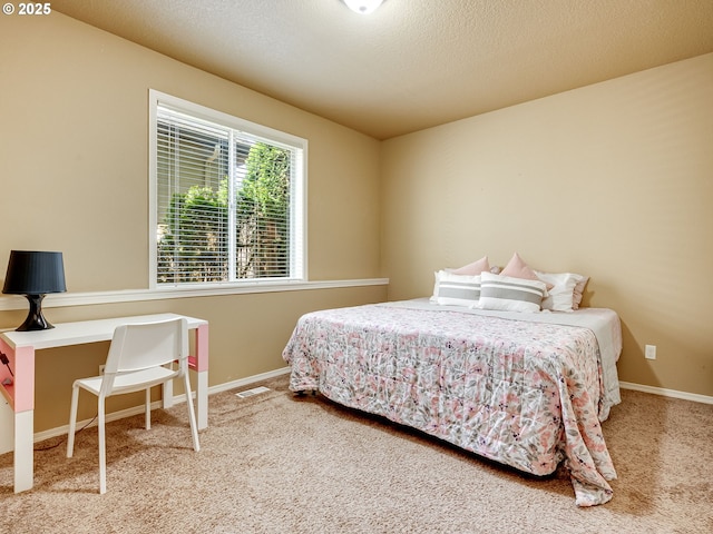 bedroom featuring baseboards, carpet flooring, and visible vents