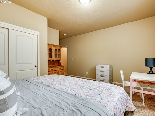 bedroom featuring a closet, carpet flooring, and baseboards