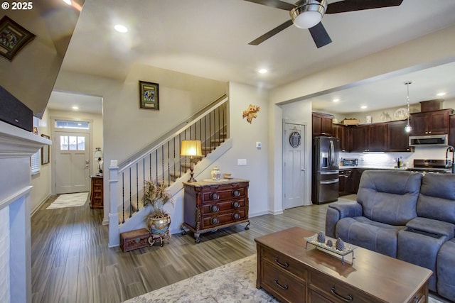 living room featuring stairs, recessed lighting, wood finished floors, and a ceiling fan