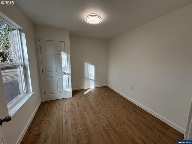 unfurnished bedroom with hardwood / wood-style floors