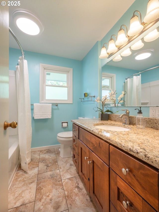 full bath with baseboards, vanity, and toilet