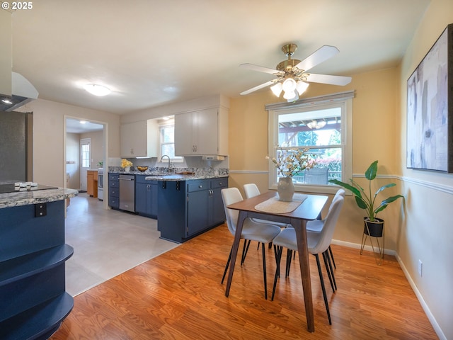 dining space featuring ceiling fan, baseboards, and light wood-type flooring
