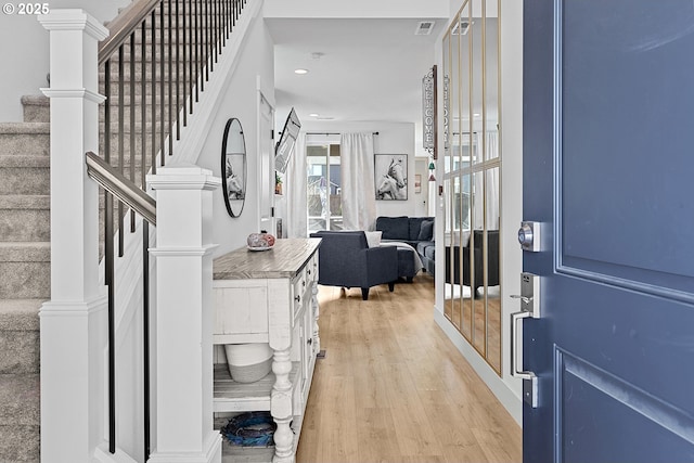 entrance foyer featuring light wood-style flooring, stairs, visible vents, and recessed lighting