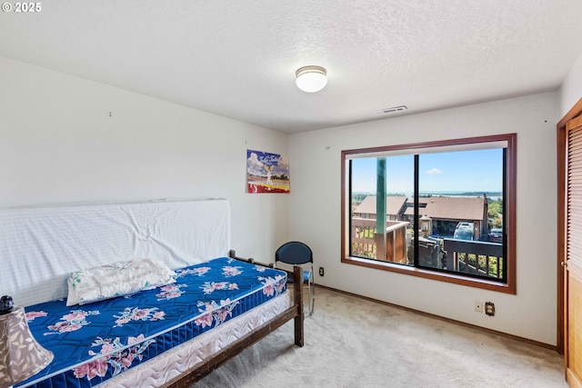 705 Prefontaine Dr, Coos Bay, OR 97420 - bedroom featuring light colored carpet, baseboards, and a textured ceiling