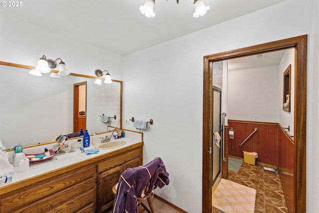 705 Prefontaine Dr, Coos Bay, OR 97420 - full bath with vanity, a chandelier, a wainscoted wall, a shower stall, and wooden walls