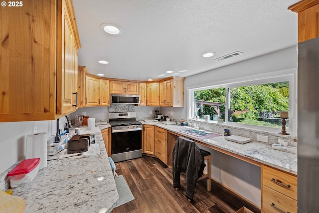 705 Prefontaine Dr, Coos Bay, OR 97420 - kitchen featuring appliances with stainless steel finishes, dark wood-style flooring, recessed lighting, a sink, and light stone countertops