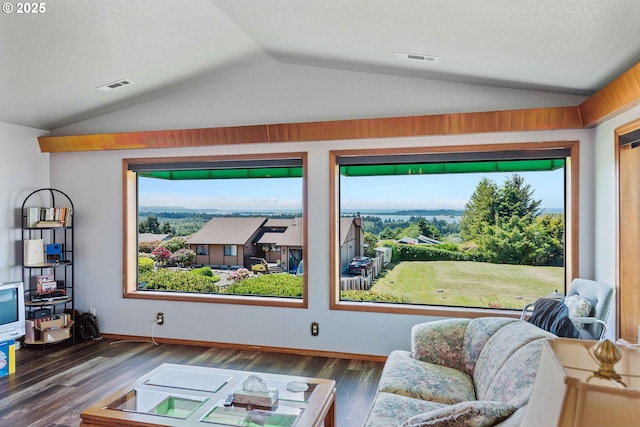 705 Prefontaine Dr, Coos Bay, OR 97420 - living area featuring lofted ceiling, wood finished floors, plenty of natural light, and baseboards