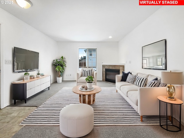 living area featuring a tile fireplace and recessed lighting