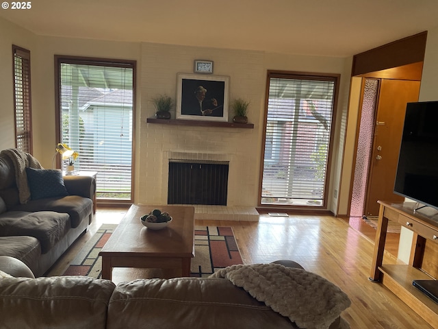 living area with a fireplace and wood finished floors