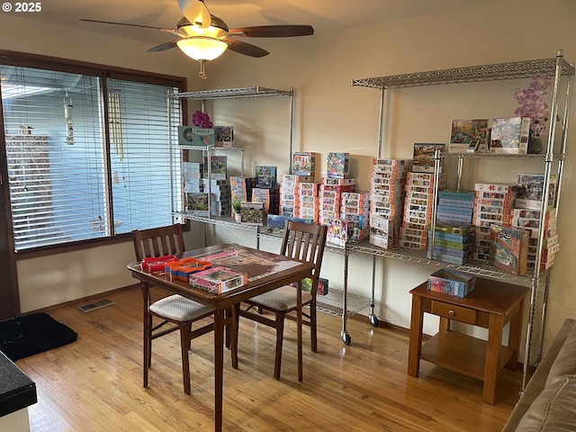 dining room with visible vents, ceiling fan, and wood finished floors