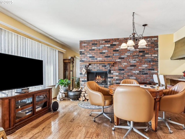 interior space featuring a brick fireplace and light hardwood / wood-style flooring