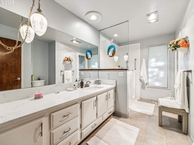 bathroom featuring vanity, toilet, and tile patterned flooring