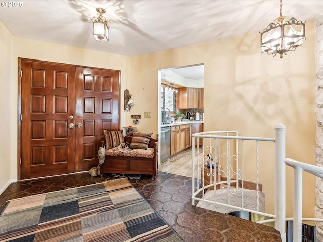 foyer entrance featuring a notable chandelier