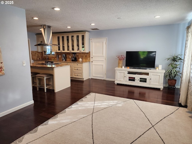 unfurnished living room with recessed lighting, baseboards, a textured ceiling, and dark wood-style flooring