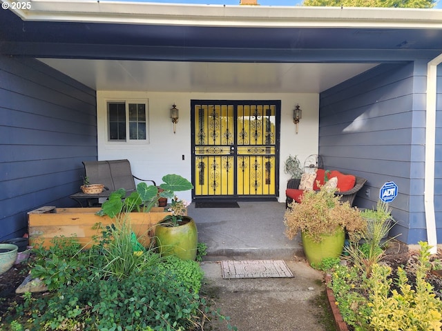 view of exterior entry with covered porch