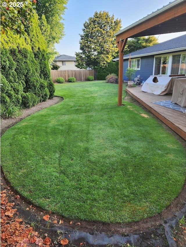 view of yard with a wooden deck and fence