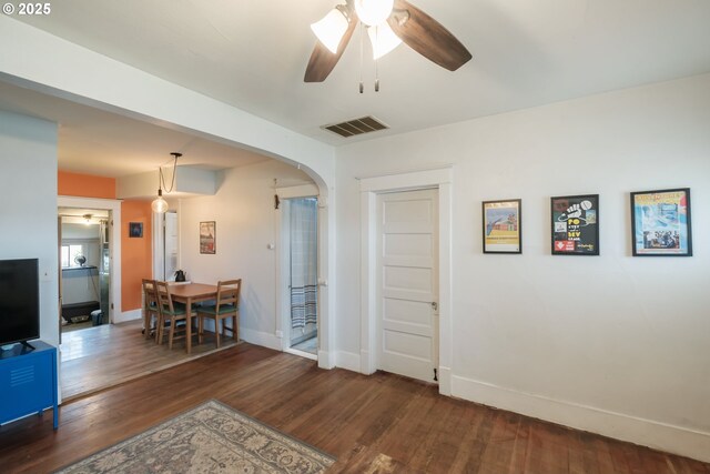 2320 5th St NE, Salem, OR 97301 - living room featuring ceiling fan, wood finished floors, baseboards, and arched walkways