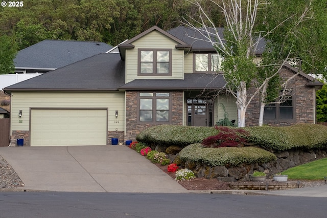 view of front of home with stone siding, a garage, and driveway
