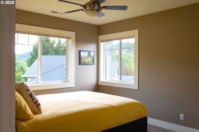 bedroom with baseboards and a ceiling fan