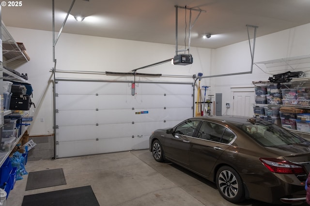 garage with a garage door opener and electric panel