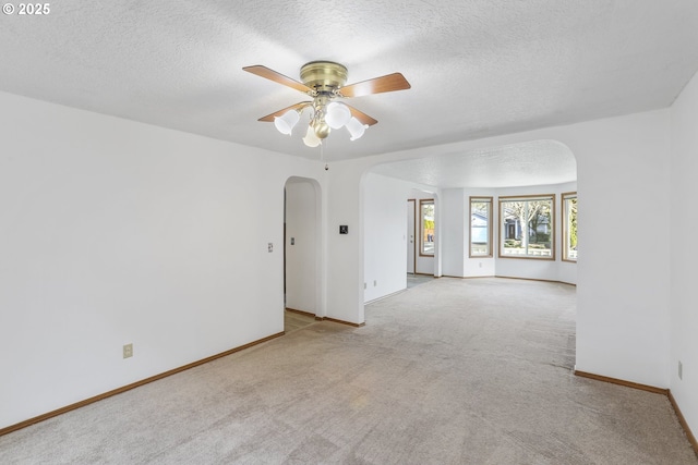 unfurnished room with light carpet, a textured ceiling, and ceiling fan