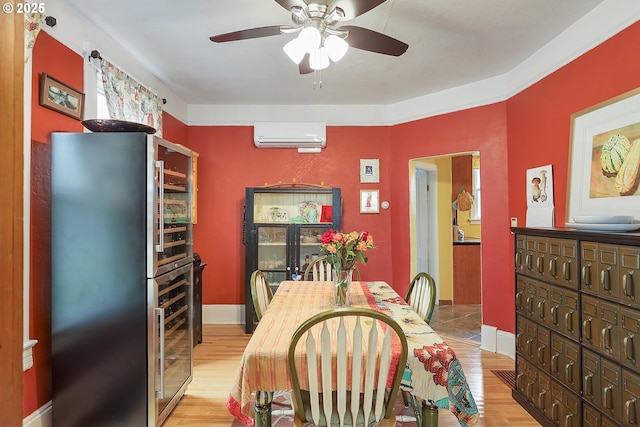 dining room featuring ceiling fan, light wood-type flooring, wine cooler, and a wall mounted air conditioner