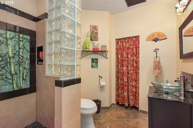 full bath with toilet, visible vents, walk in shower, and vanity