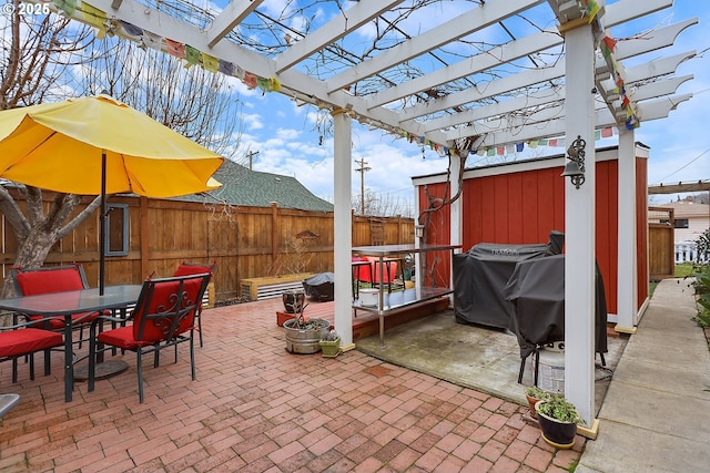 view of patio with outdoor dining space, a grill, fence, and a pergola