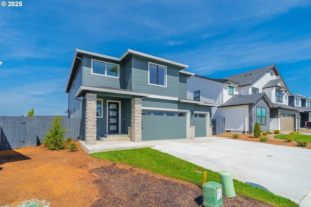 4308 N 12th Way, Ridgefield, WA 98642 - view of front of house with fence, stone siding, an attached garage, driveway, and a residential view