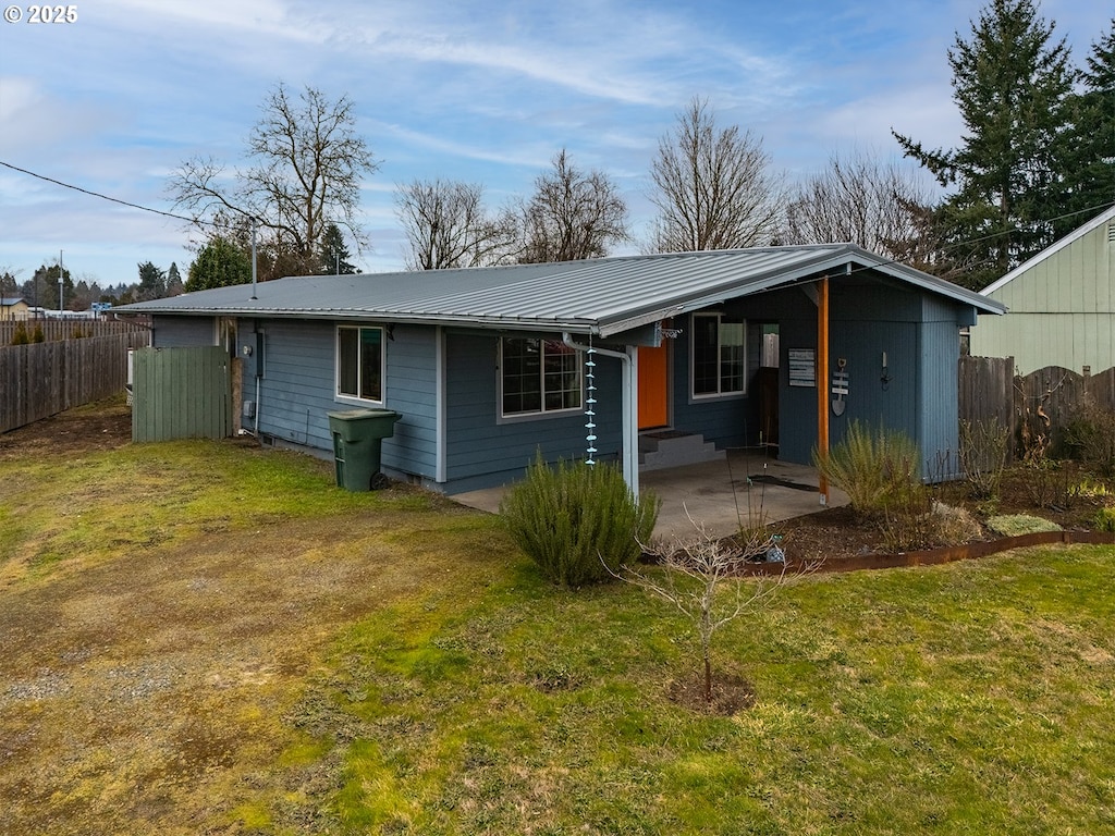 view of front of house with a patio area and a front lawn