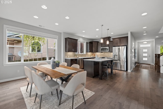 dining space featuring recessed lighting, baseboards, visible vents, and wood finished floors