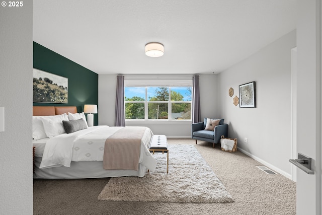 bedroom featuring baseboards, carpet, and visible vents